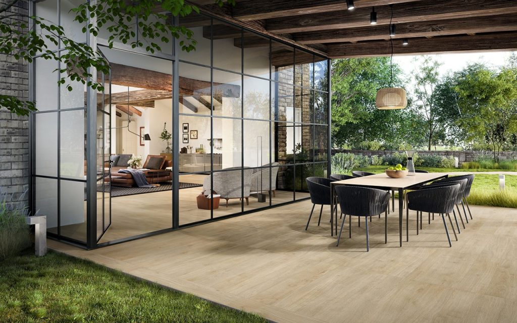 Honey-toned timber-look porcelain tiles flowing from an indoor living area out to an alfresco dining space